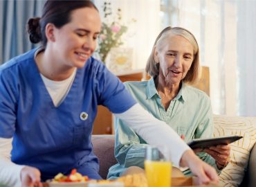 Breakfast, nurse and senior woman in nursing home for elderly care, nutrition and support. Retired